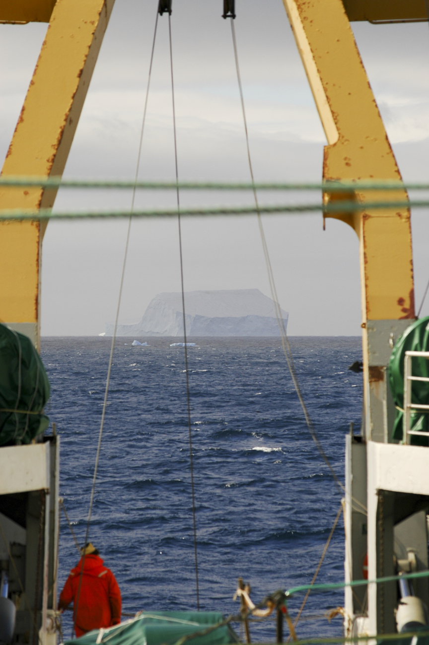 A scientist looks at an iceberg from the aft deck of the R/V Yuzhmorgeologiya
