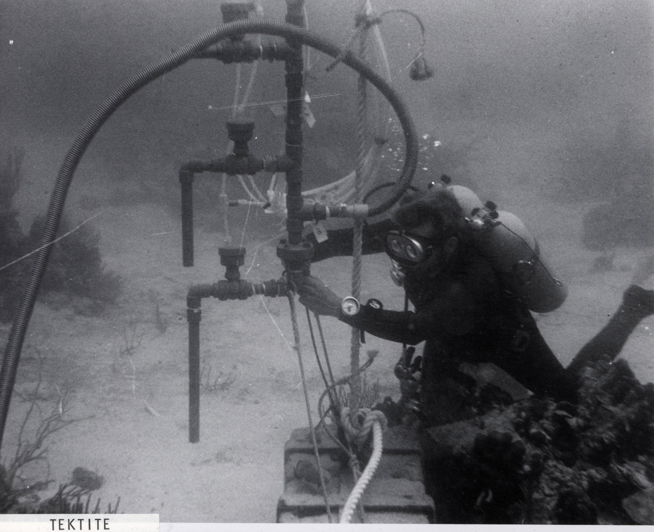 Tektite aquanaut working on experimental equipment