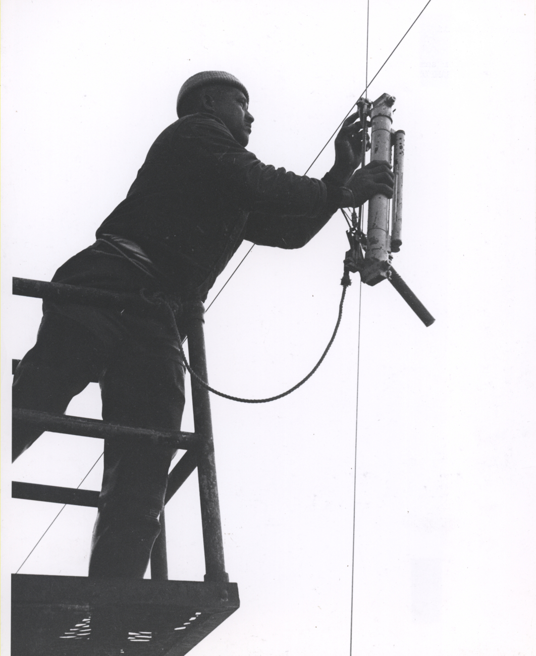 Deploying a Nansen bottle, used for measuring sub-surface temperature andto collect water samples for analysis