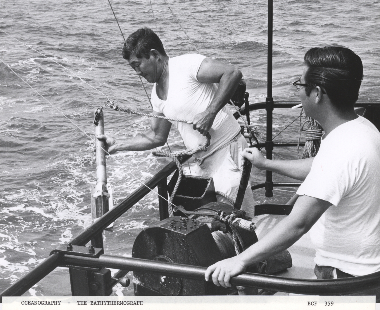 Deploying a bathythermograph from a fisheries research vessel