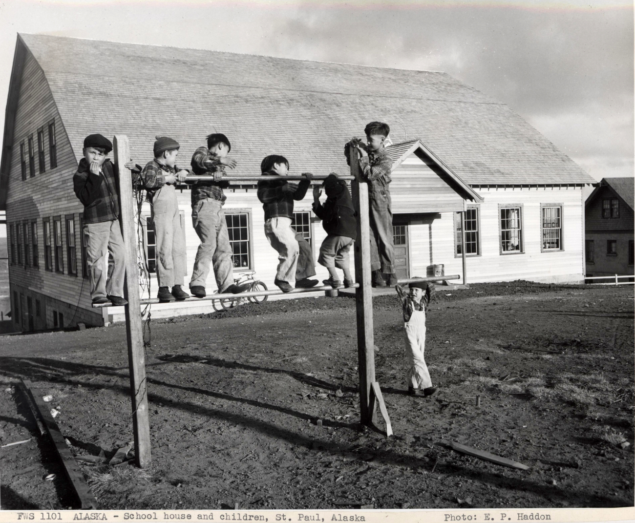 The schoolhouse with children playing at recess