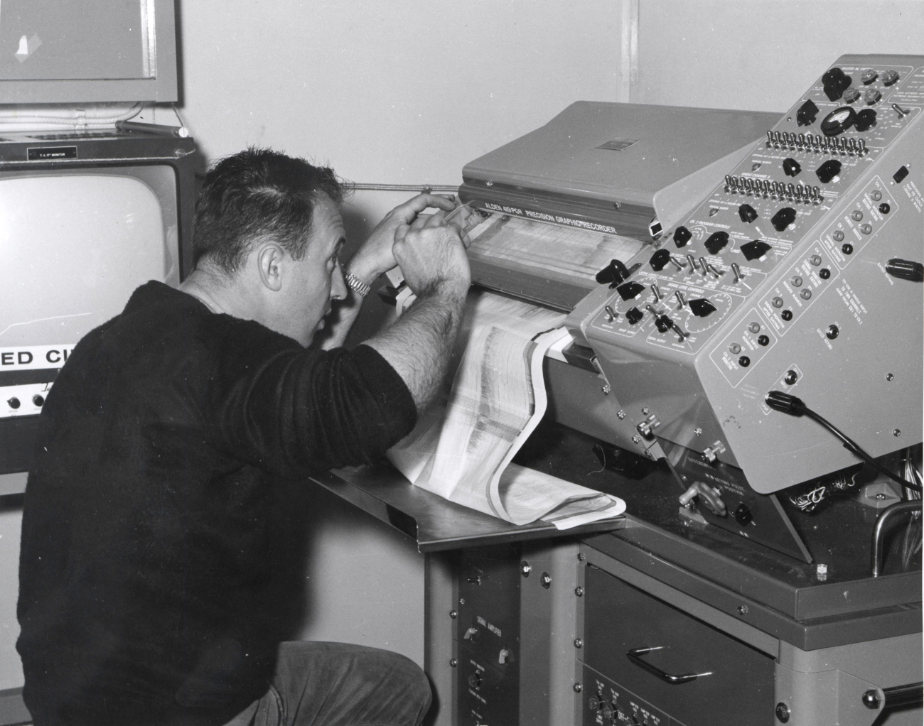 Electronics technician working on depth recorder on ALBATROSS IV