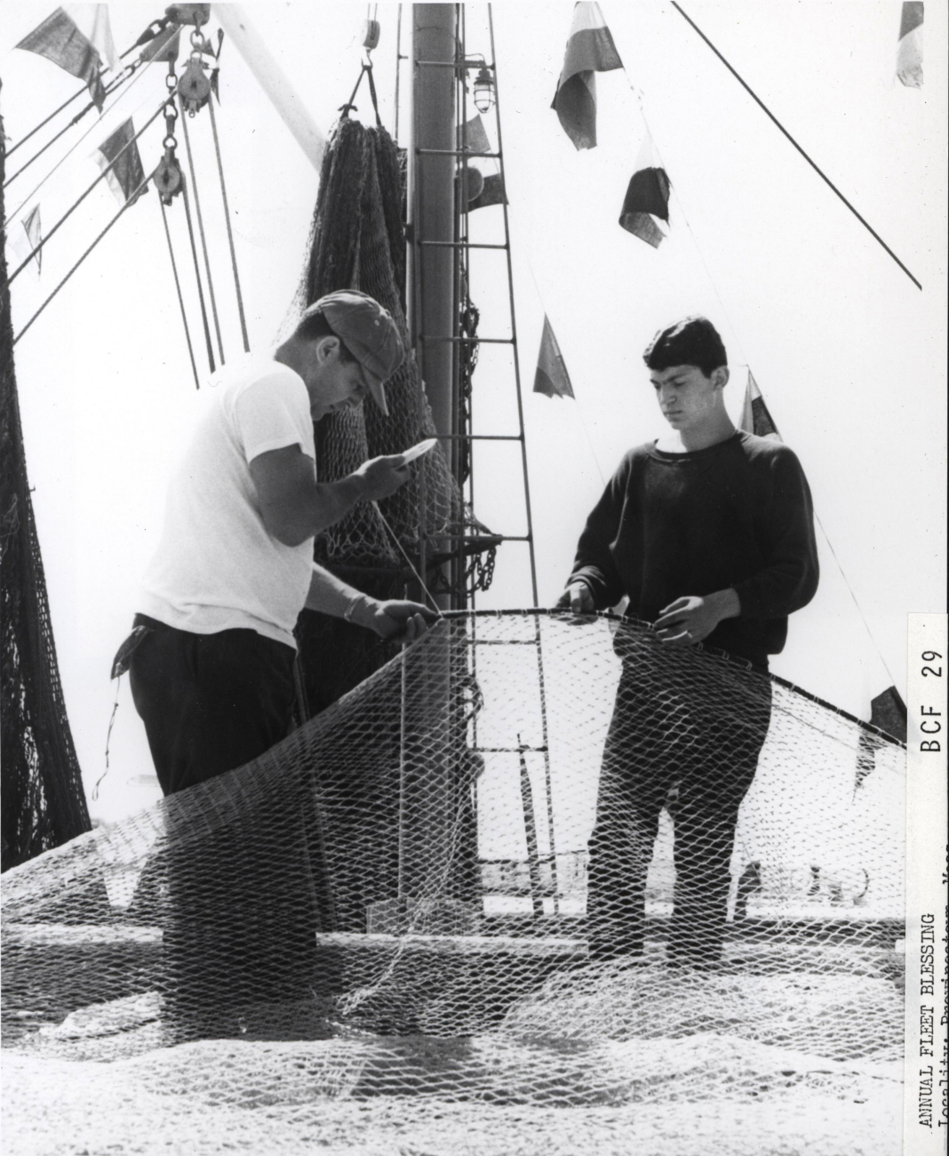 Repairing nets at Provincetown preparatory to Annual Fleet Blessing