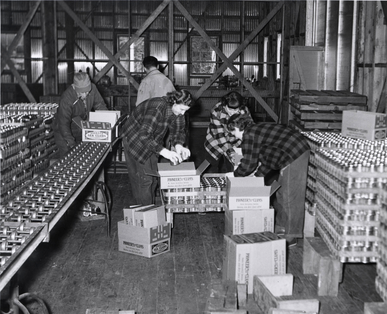 Cans of Pioneer Sea Clams being readied for shipment