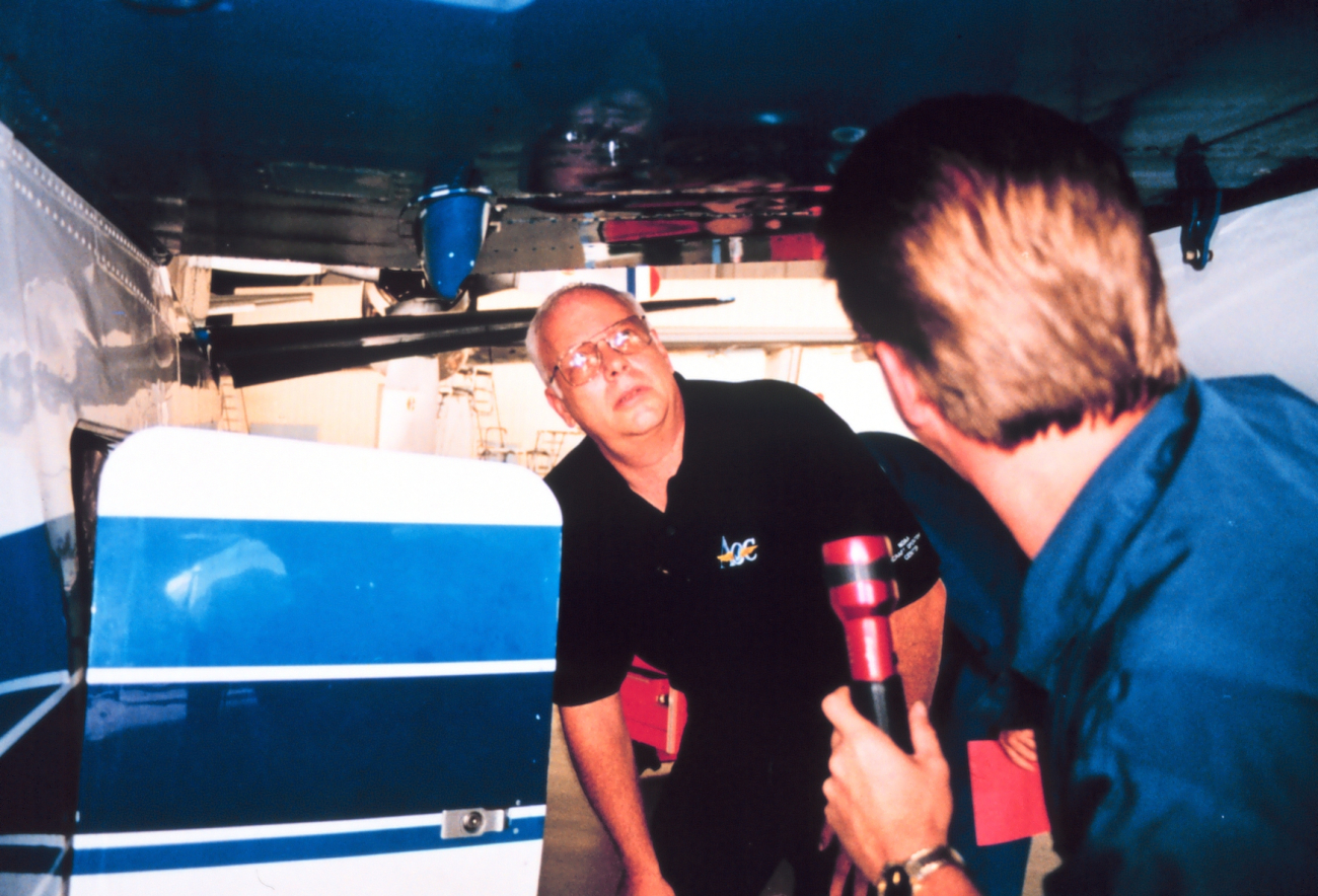 Greg Bast and Mike Merek performing maintenance on Twin Otter