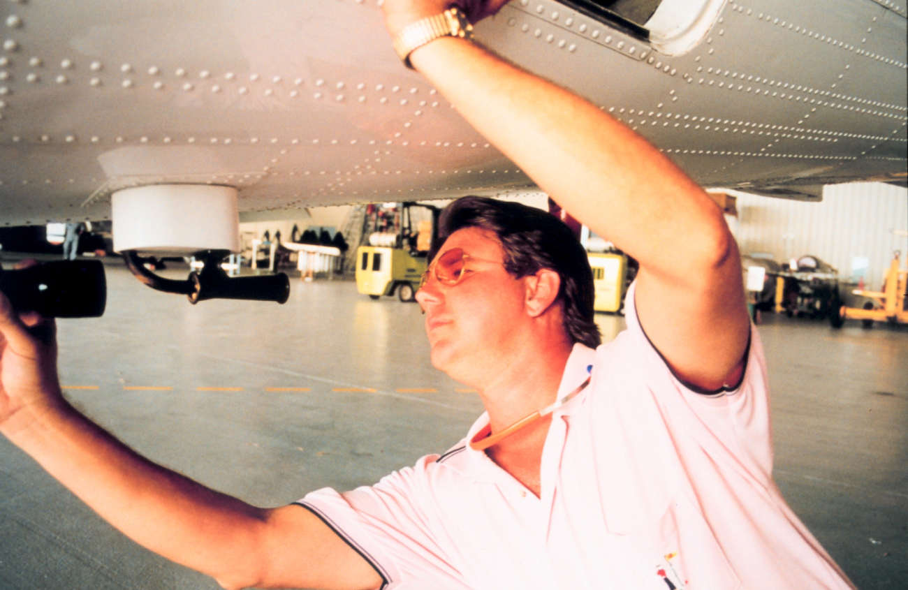 Mike Merek performing maintenance on NOAA aircraft