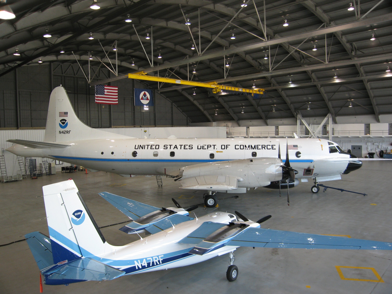 Lockheed WP-3D Orion N42RF and Rockwell Aero Commander (AC-500S) N47RFin hangar at MacDill Air Force Base