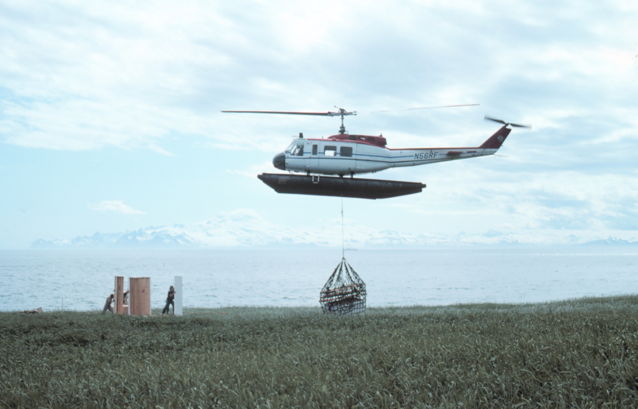 Bell UH-1H N56RF at Cape Douglas sling-loading camp equipment for shore camp