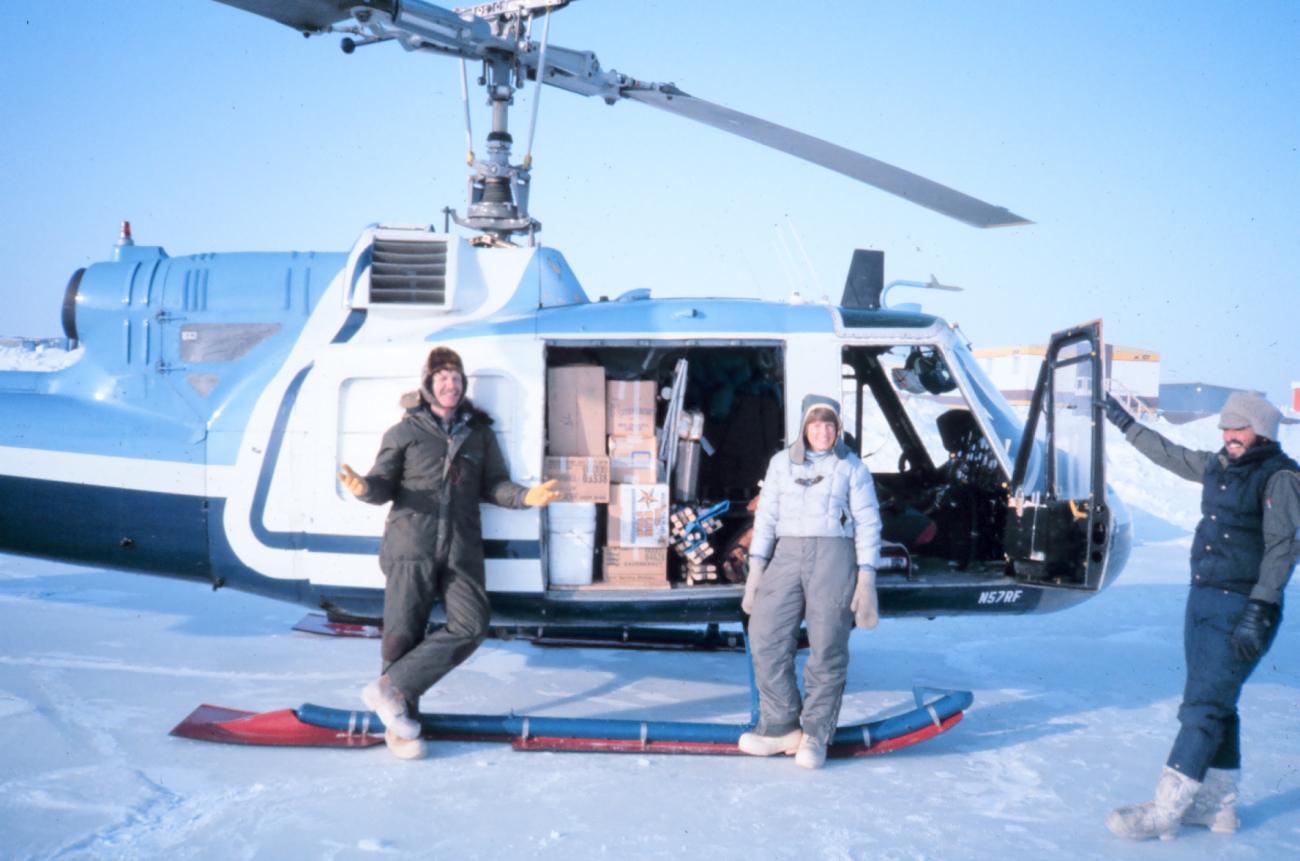Brendan Kelley and Lori Quackenbush of the University of Alaska Fairbanks andNOAA helicopter mechanic Russ Talley (on right) loading Bell UH-1M withgear for remote camp from Reindeer Island