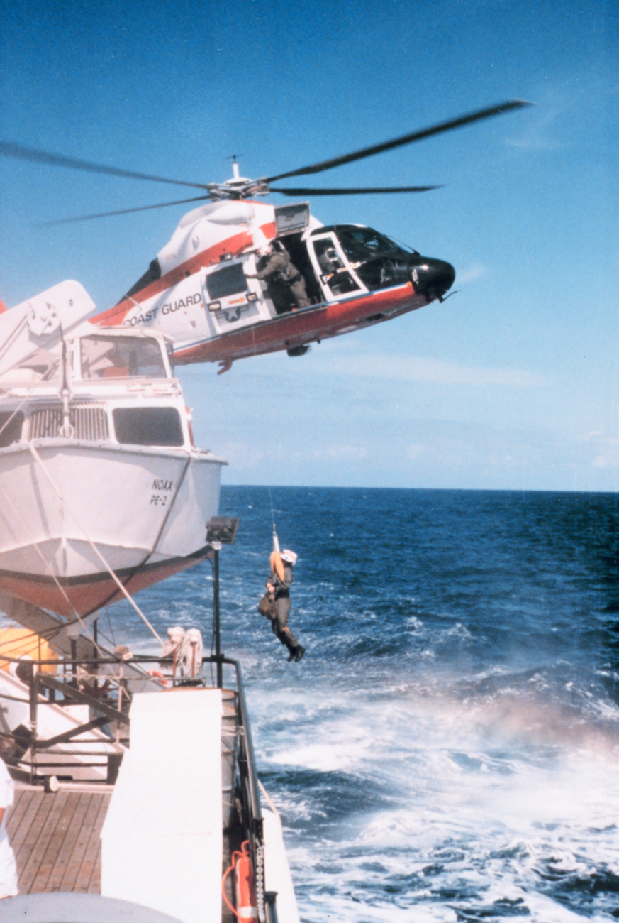 Coast Guard helicopter conducting medivac of NOAA Ship PEIRCE crewmanduring transit from Puerto Rico to Beaufort, North Carolina