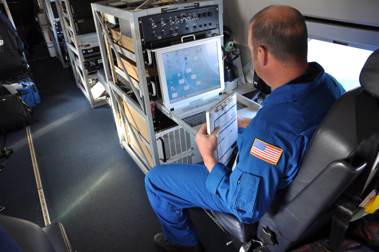 Lead Electronics Technician Gabriel Defeo aboard NOAA Gulfstream IVjet during February 2013 mission out of Honolulu_