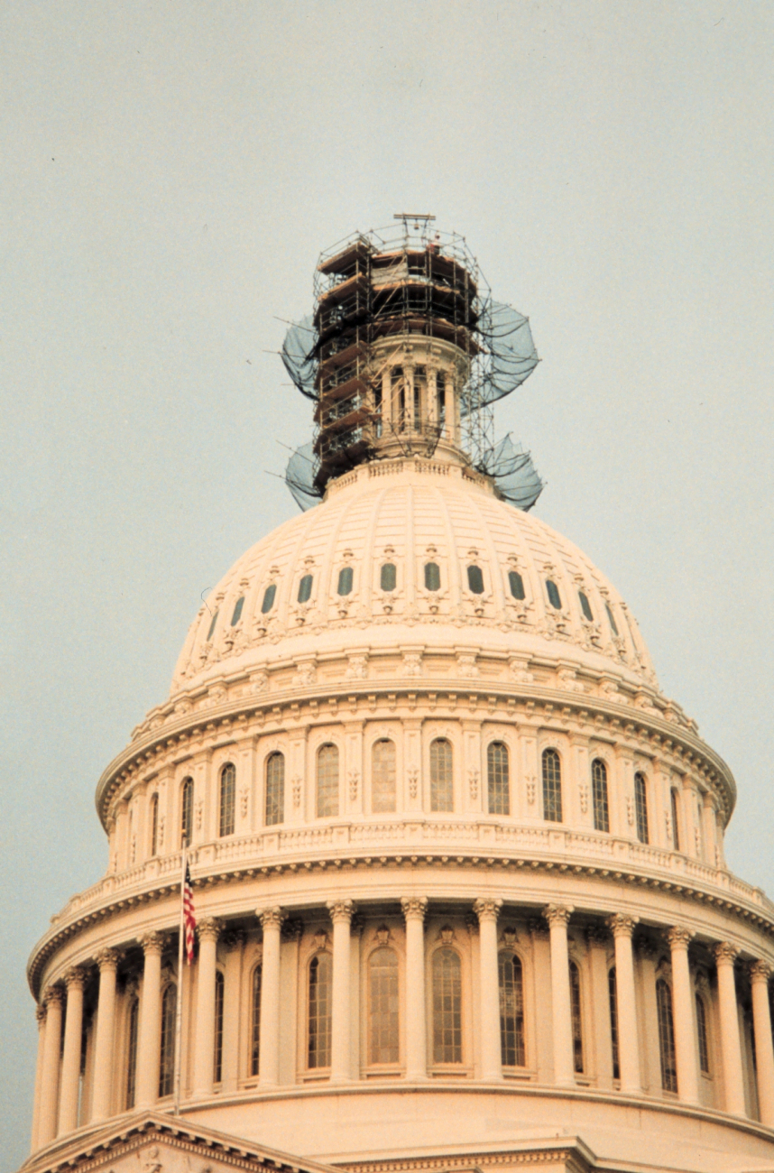 Looking SW from ground at scaffolding surrounding the top of the CapitolBuilding with the Statue of Freedom removed