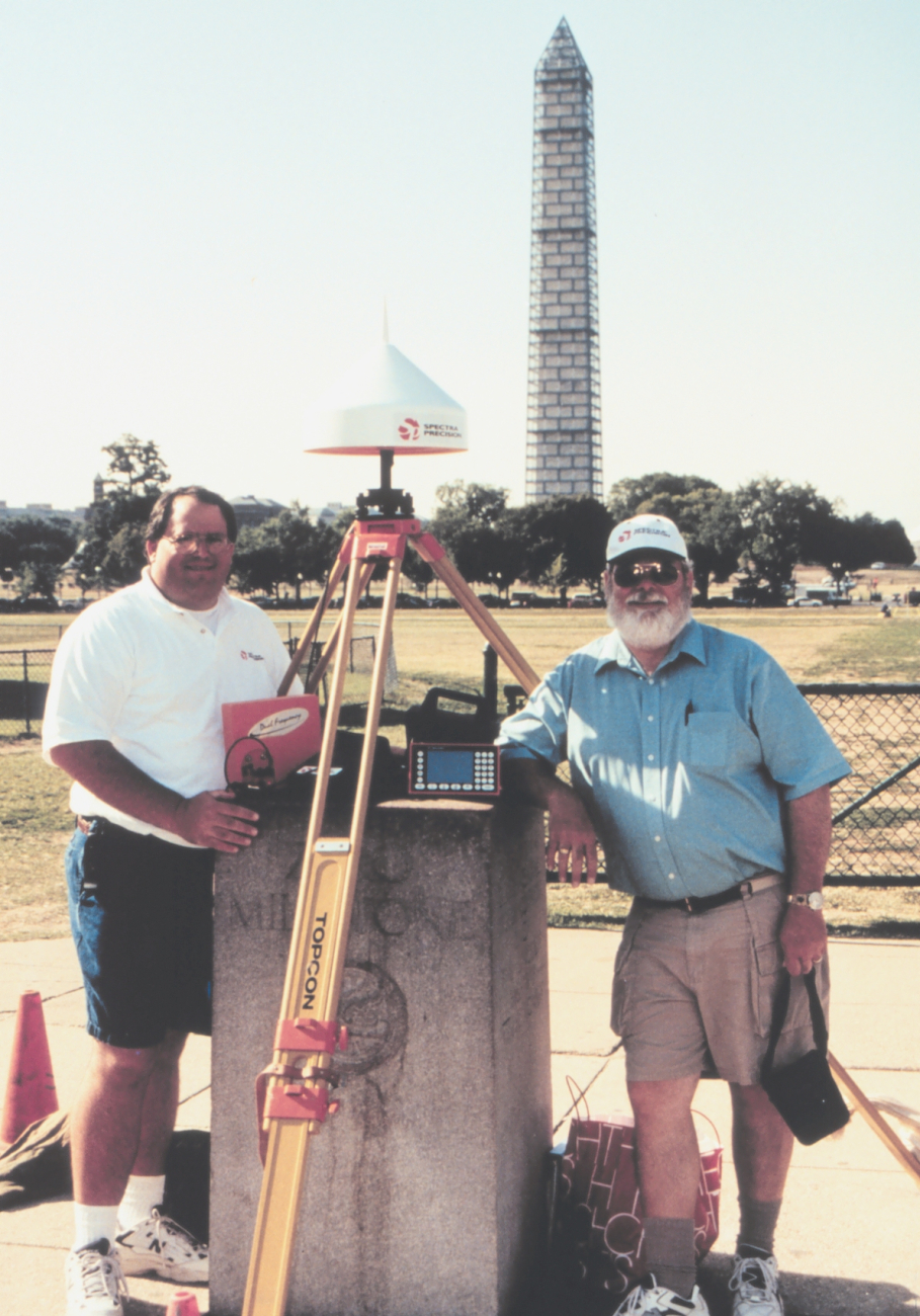 Mike Nixon (L) and Ellis Veatch occupying the Zero Milestone of the Chesapeakeand Ohio Canal with the Washington Monument in the background