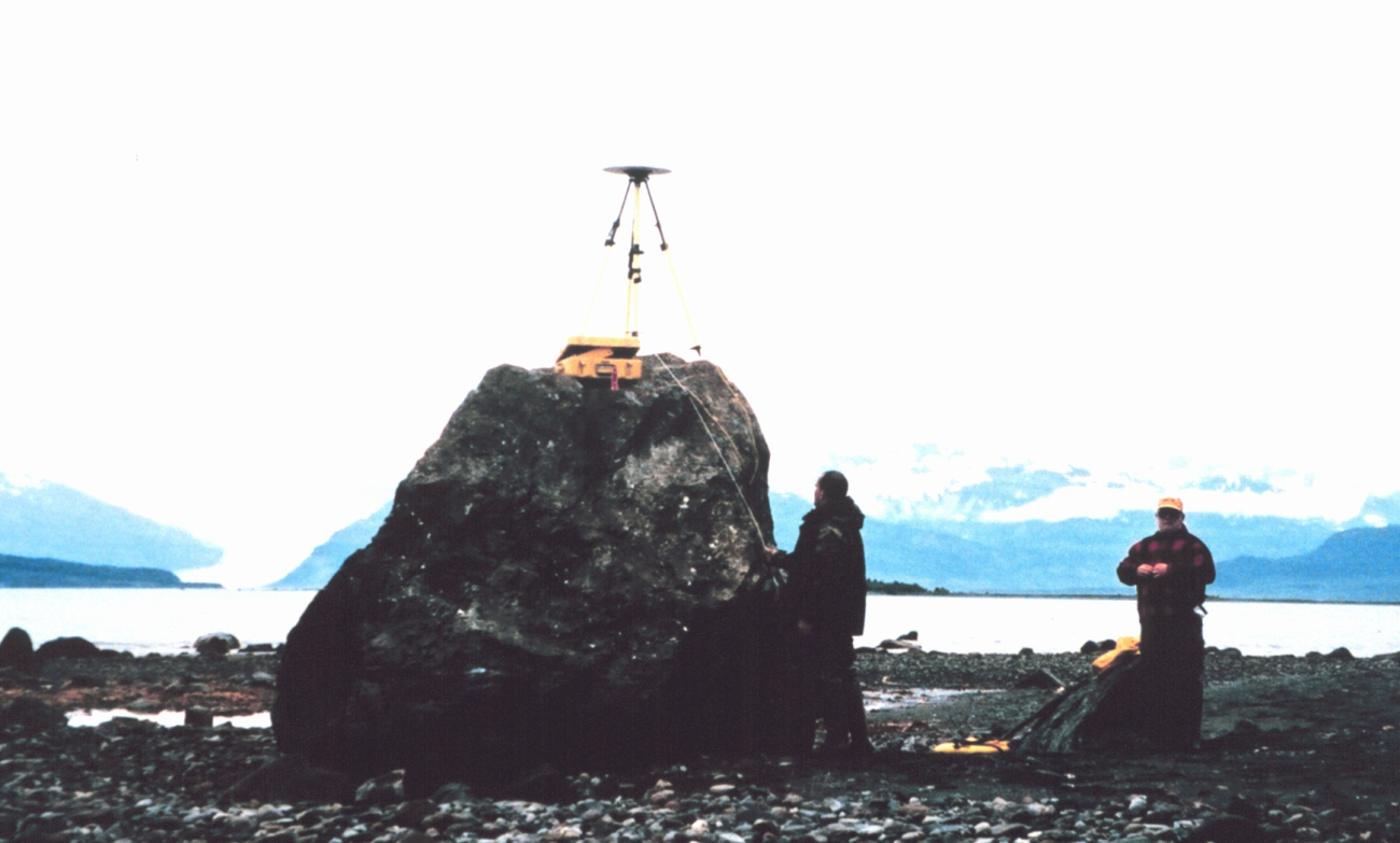 GPS antenna and tripod set up over tidal bench mark on rock