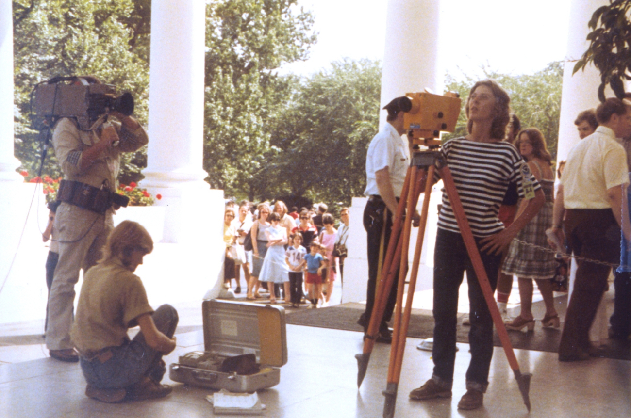 Anita Whitis being filmed by news crew while conducting leveling operations onthe North Portico of the White House