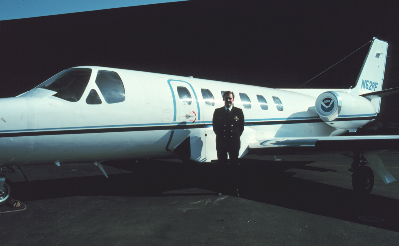 Pilot, Commander Bob McCann, standing byNOAA Cessna Citation II N52RF at Dulles International Airport