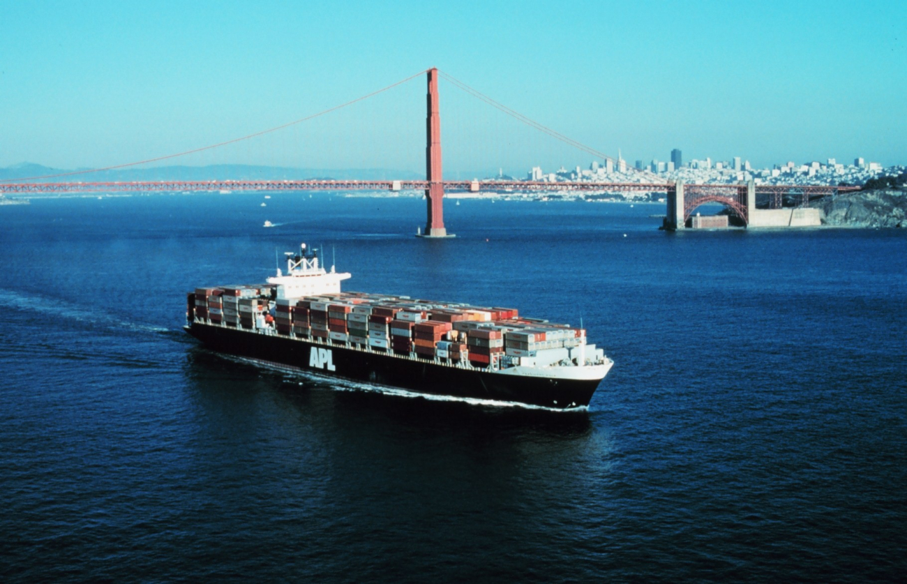 An outward bound containership with the Golden Gate and SanFrancisco skyline in the background