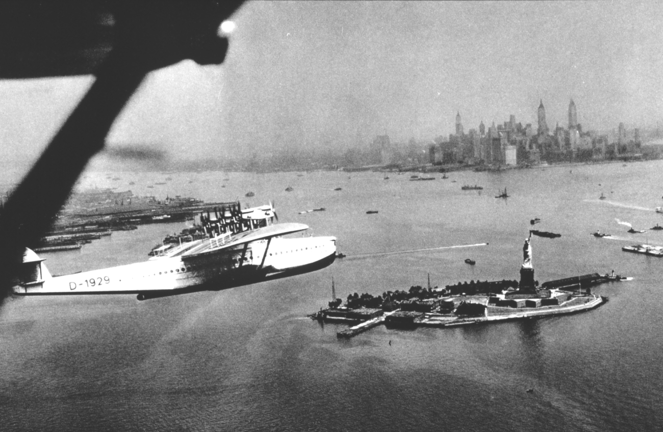 A flying boat on arrival at New York passing over the Statue of Liberty