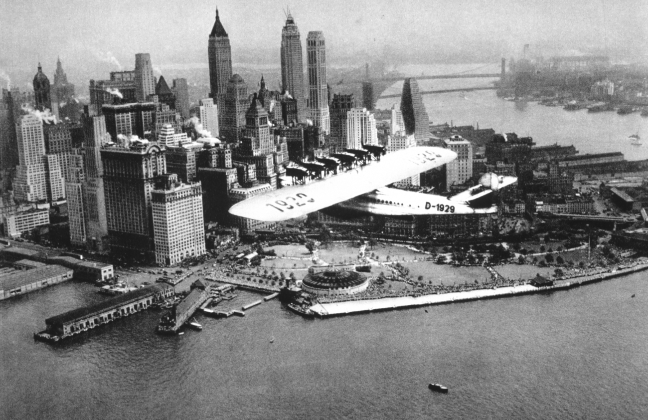A flying boat cruising by Battery Park at the south end of Manhattan Island