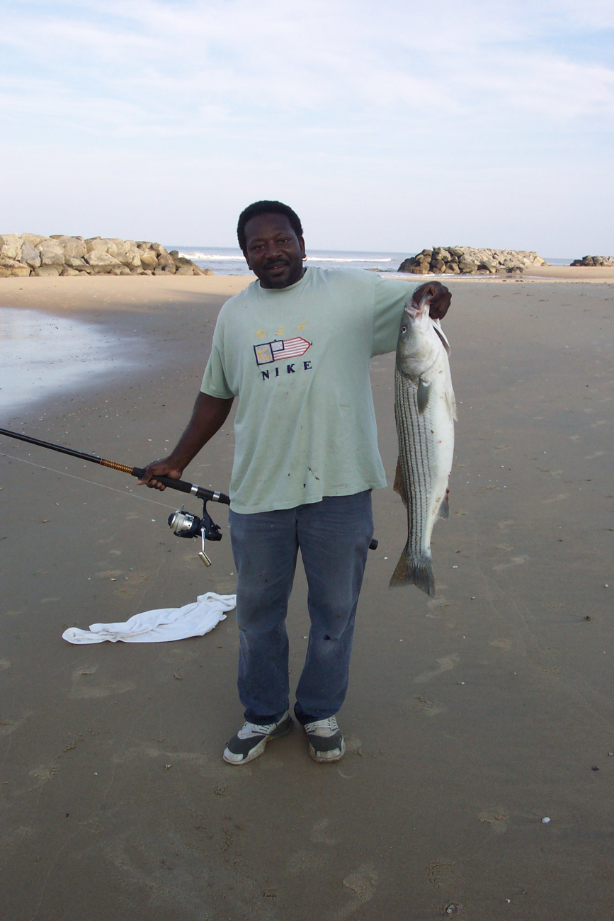 A lucky fisherman with a striped bass at Cape Henry