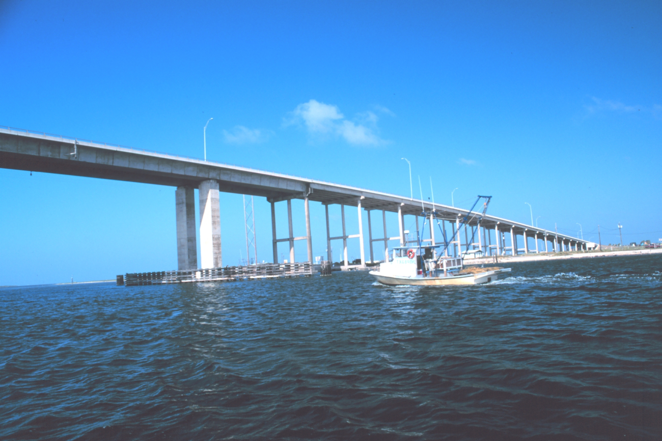 A shrimp boat headed north along the Intracoastal Waterway passing under the JFK Causeway