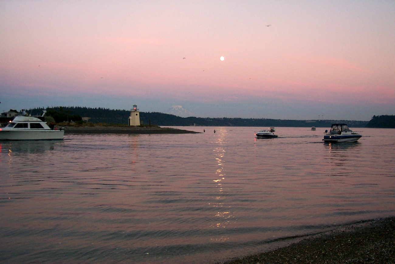 Moonrise over Gig Harbor as salmon fishermen try their luck in the shallows offthe spit