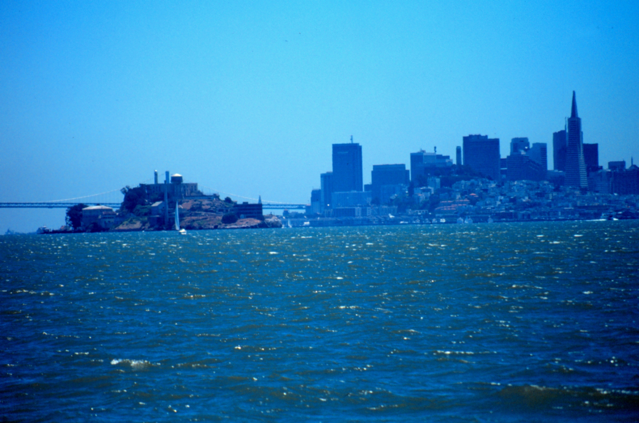 Alcatraz Island, the Oakland Bay Bridge,  and the San Francisco skyline as seenfrom a small boat looking south
