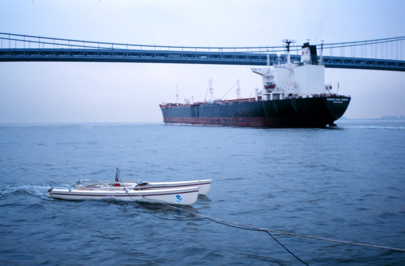 An outbound ship passes under Verrazano Narrows Bridge as a NOAA modifiedcatamaran takes mobile current profiles with an acoustic data collectionplatform (ADCP)