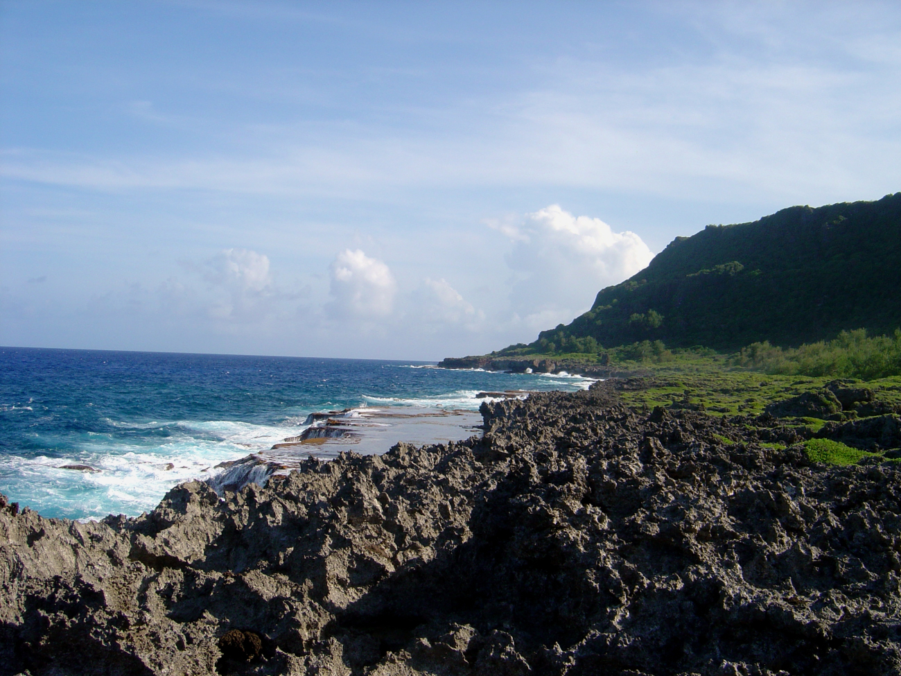 Sharp eroded coral rock makes a treacherous path down to an erodedwave-cut terrace on the Guam coastline