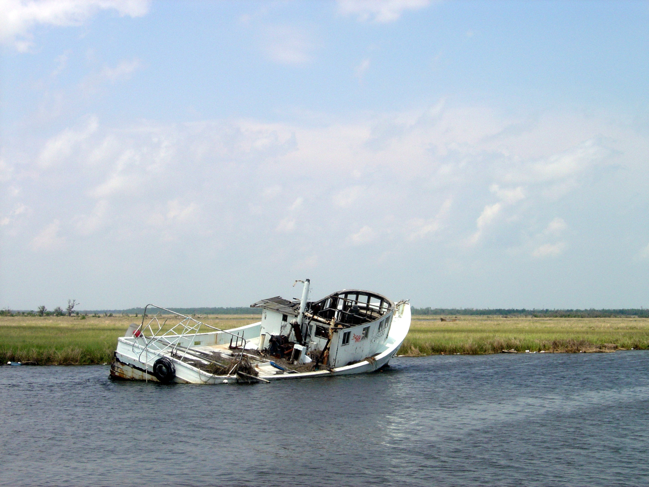A derelict shrimp vessel stranded in the marsh following Hurricane Katrina