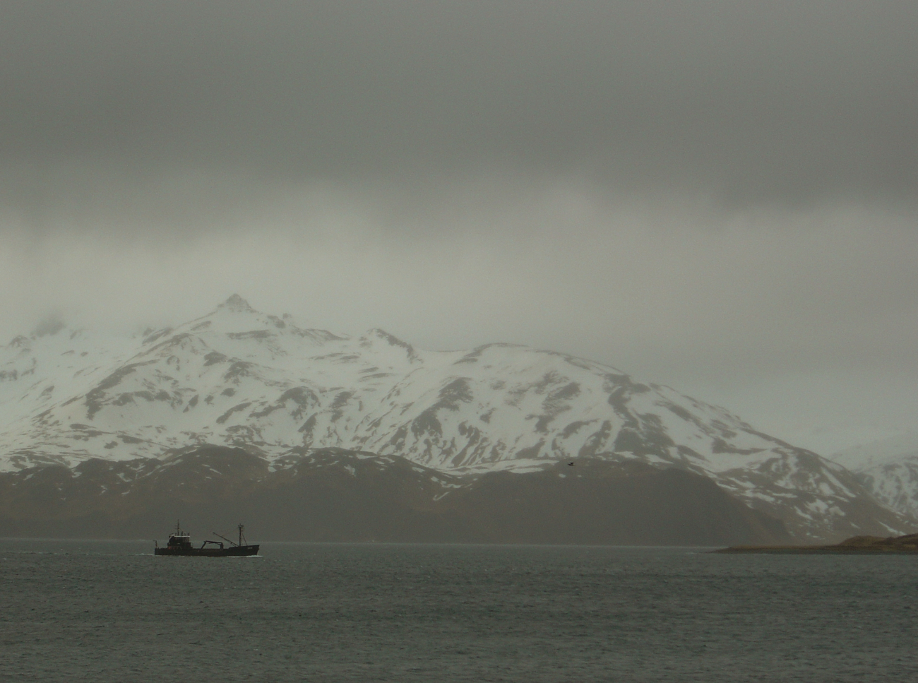 Overcast skies as a crab boat leaves harbor