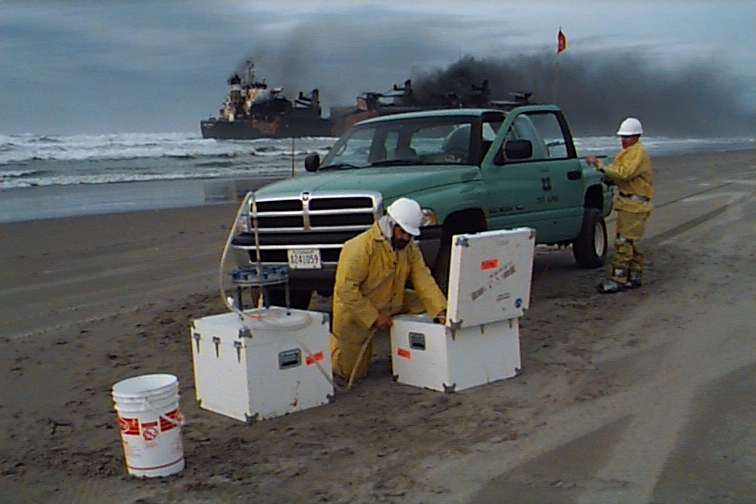 Setting up equipment to sample oil spill near grounded vessel