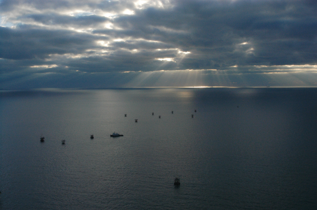 Winter sky over the Gulf of Mexico seen from the air as tugboat servicesoffshore wells
