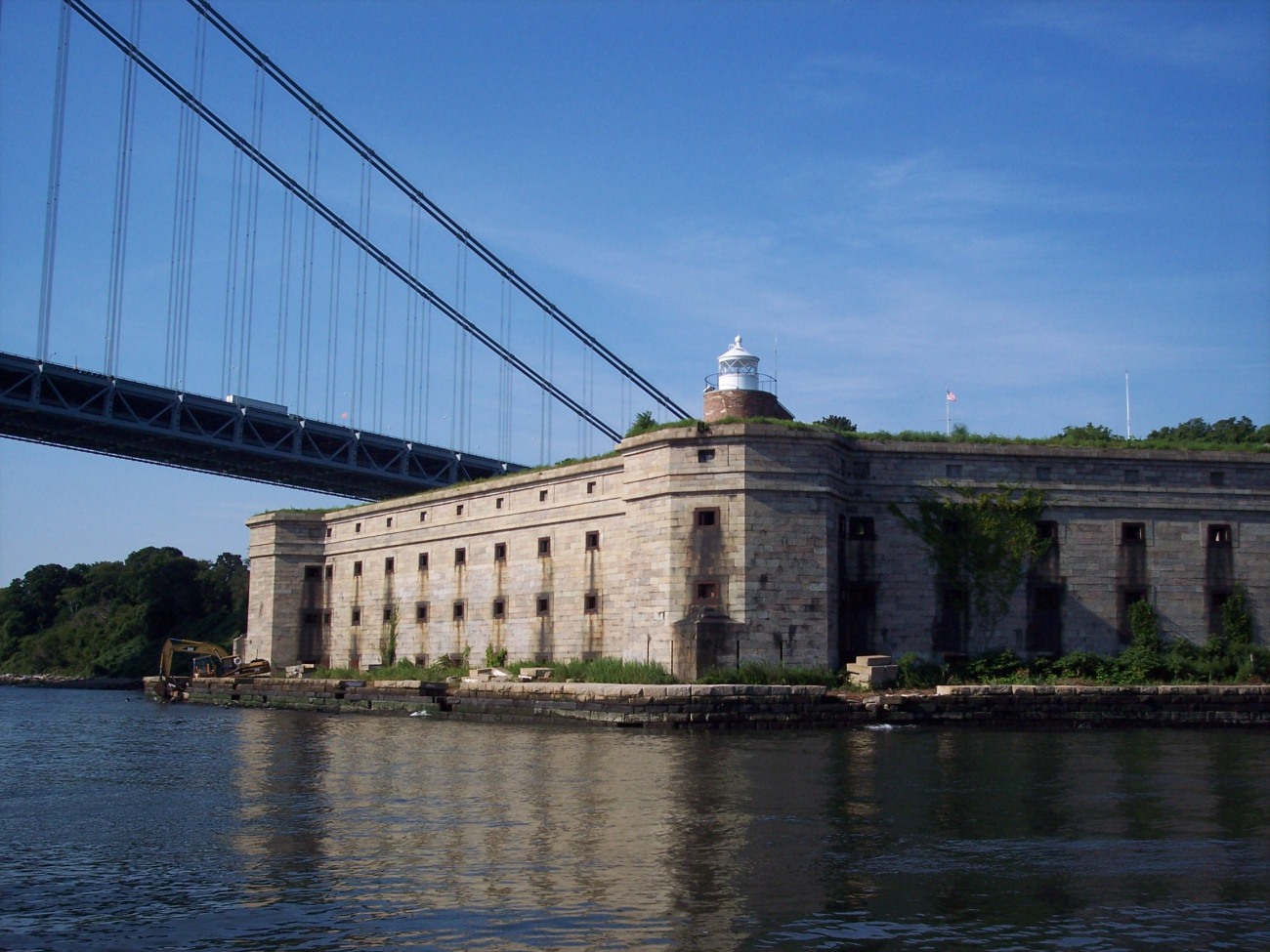 Fort Wadsworth and the Fort Wadsworth Lighthouse with the westernterminus of the Verrazano-Narrows Bridge in the background