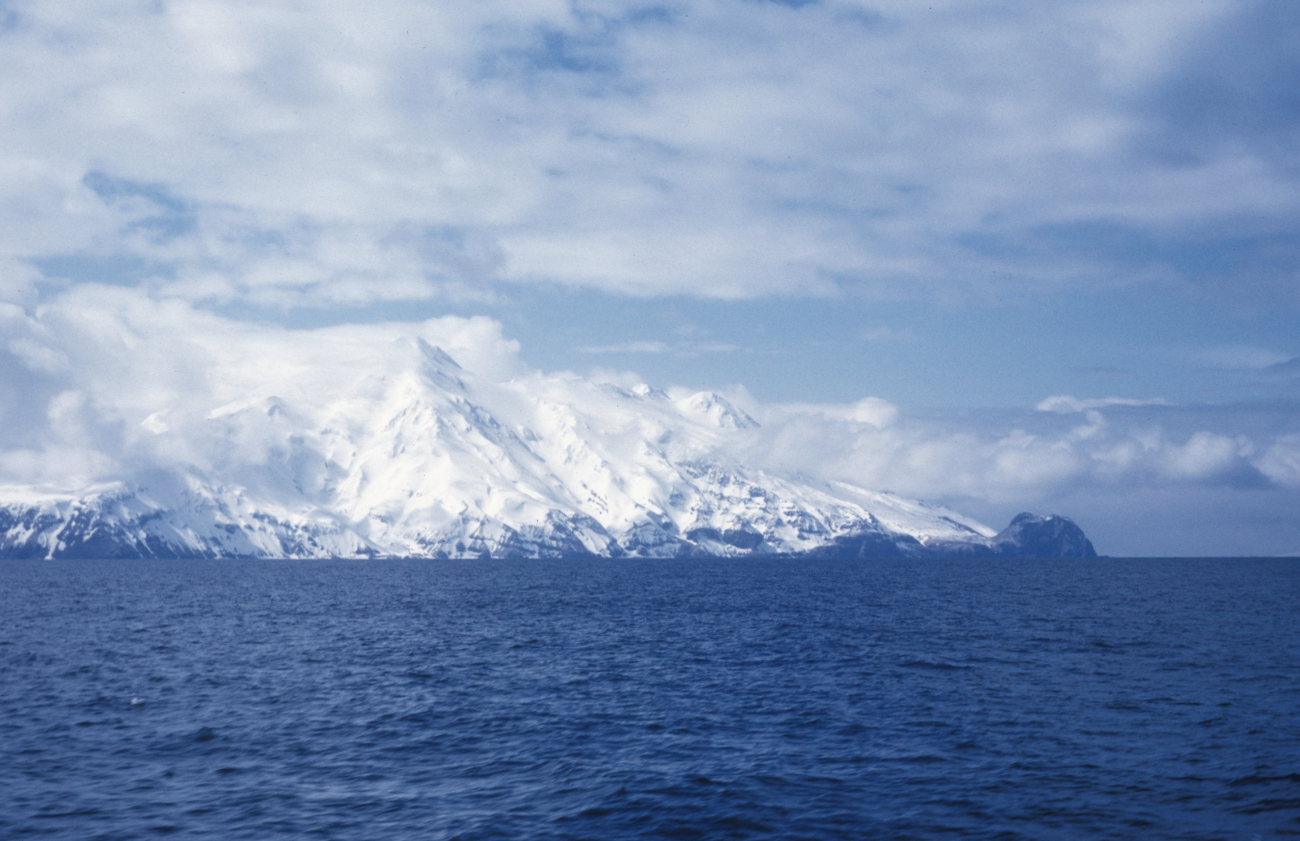 Snow-covered Aleutian volcano seen from offshore
