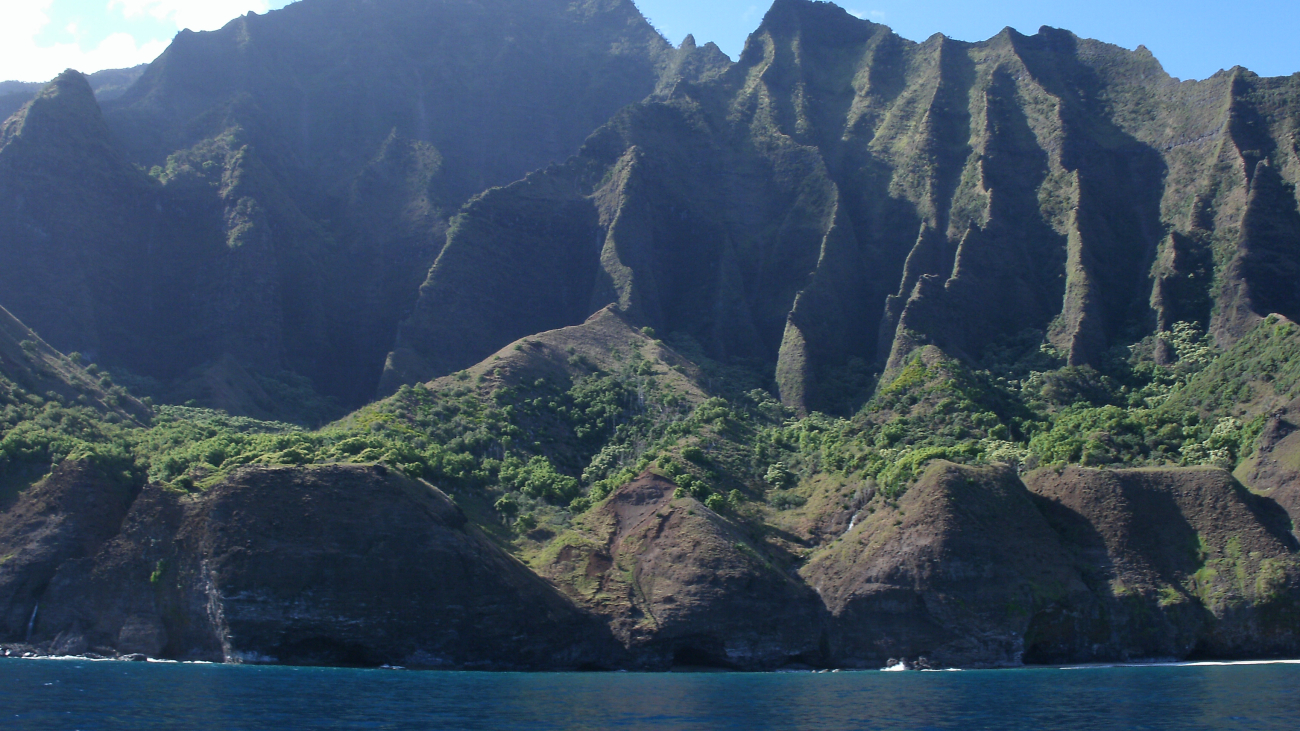 A view from the sea of the sculpted volcanic terrain of the Na Pali coast