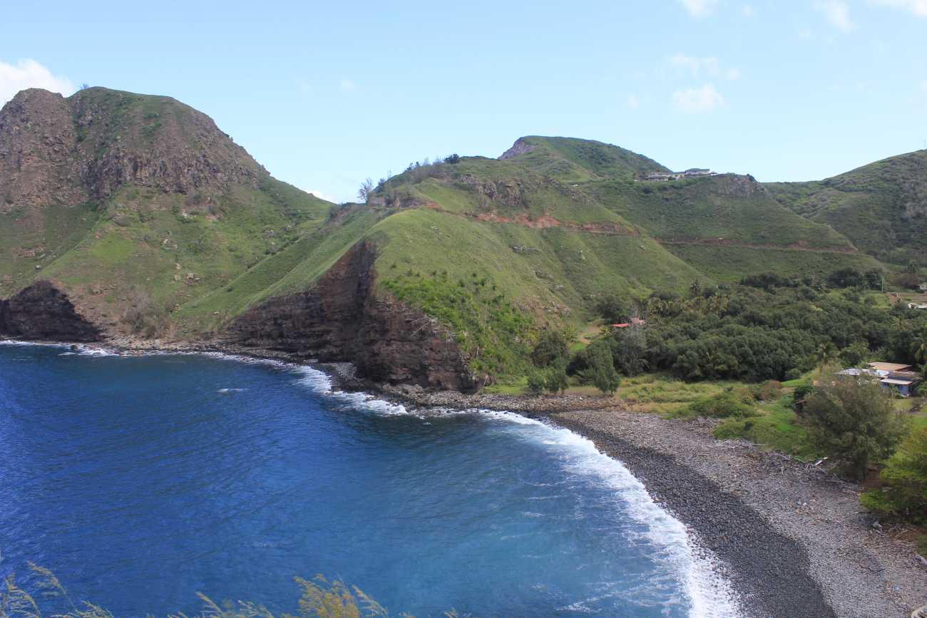 A rural settlement along the Maui coast with a cobble beach lining a quiet cove