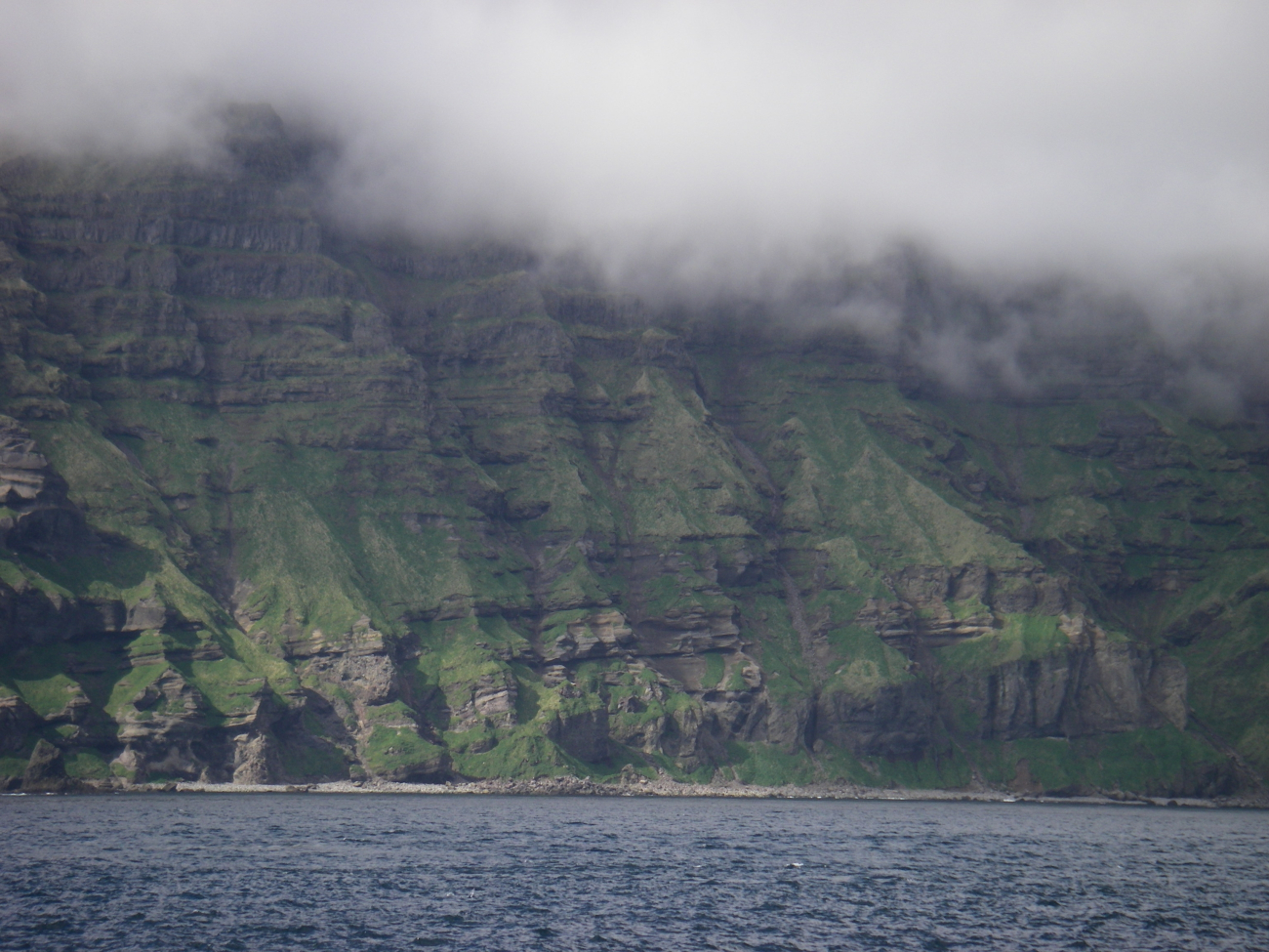 Layer upon layer of volcanic flows formed this cliff on Unimak Island