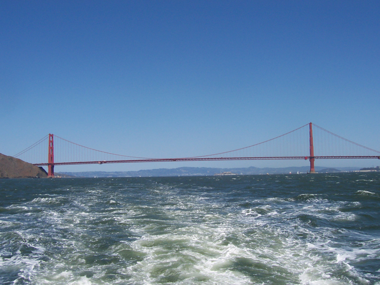 The Golden Gate Bridge seen astern with Alcatraz Island in theright center