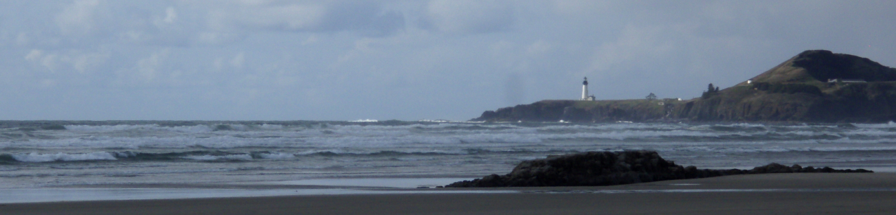 The beach at Newport with Yaquina Head Lighthouse in the distance