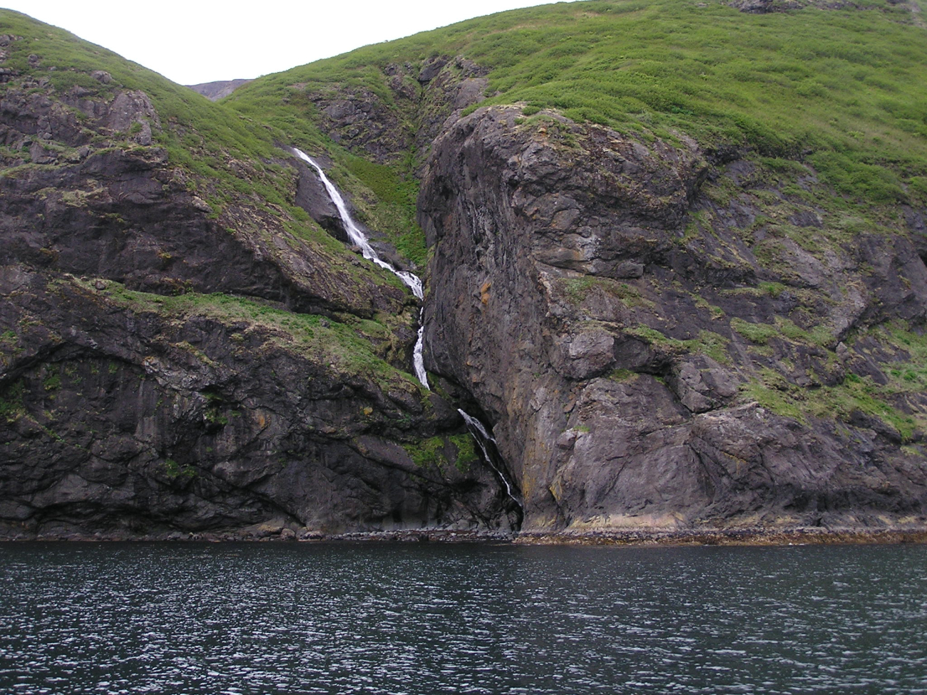 A small waterfall finding its way to the sea on a Shumagin Island