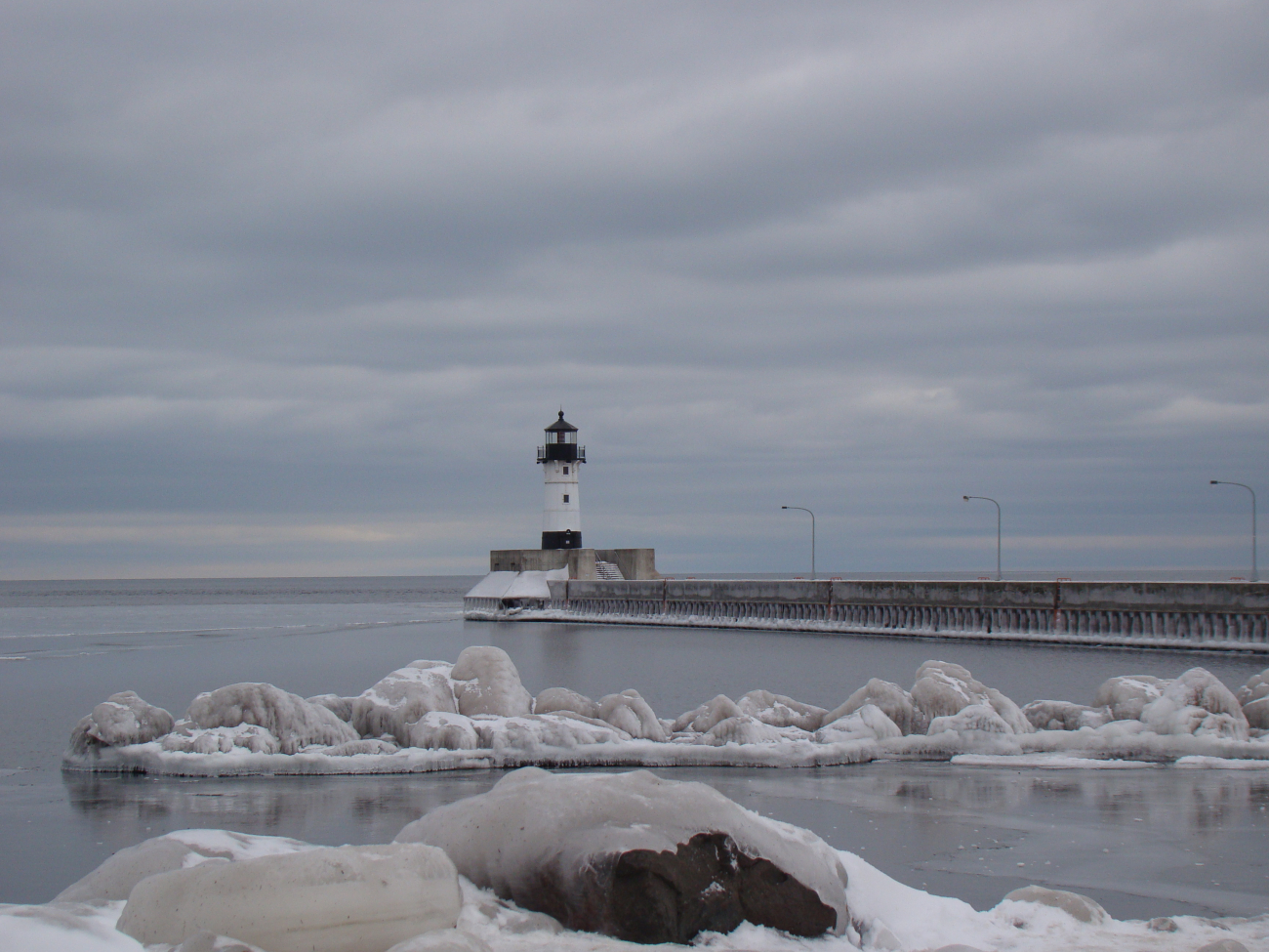 Canal Park Pier ramp and Duluth Harbor Lighthouse on a cloudy winter day