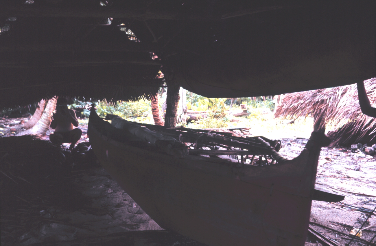 Native outrigger canoe in storage house