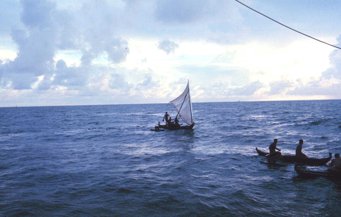 Native Micronesian fishermen greeting the TOWNSEND CROMWELLFew Micronesians use traditional sailing outrigger canoes today