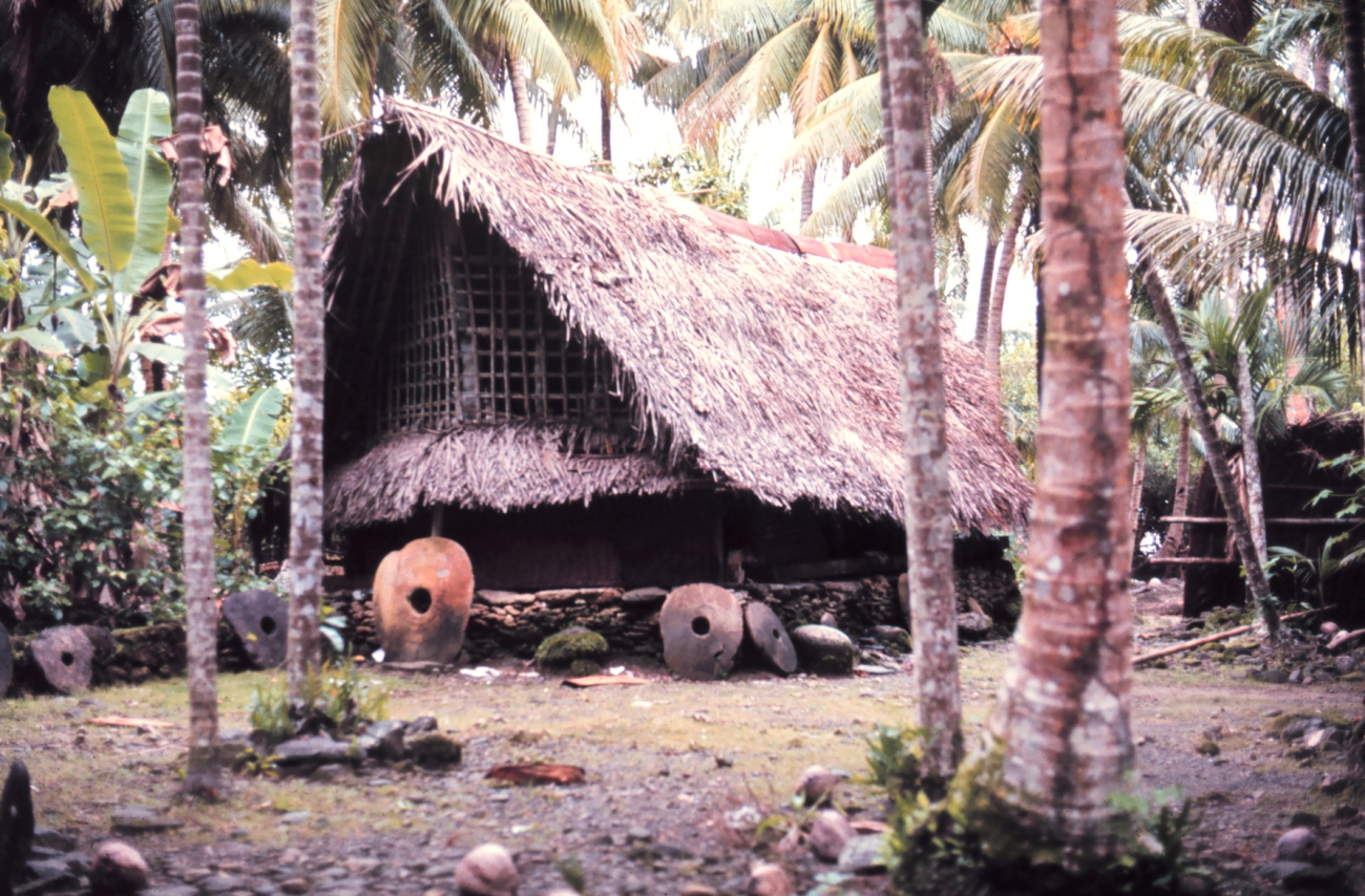 Native home with Yapese money stones indicating great wealth