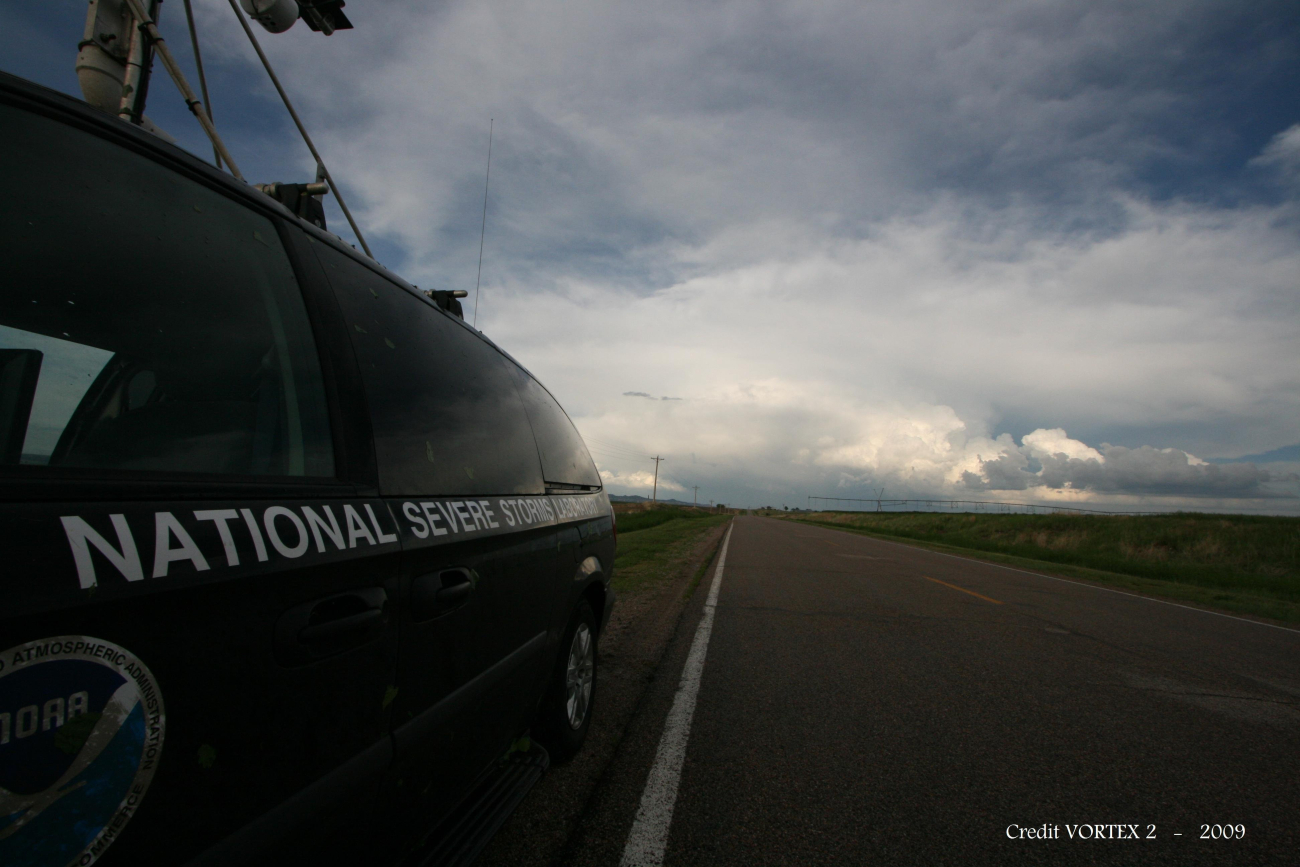 Mobile Mesonet vehicle stopped alongside the road with storm ahead