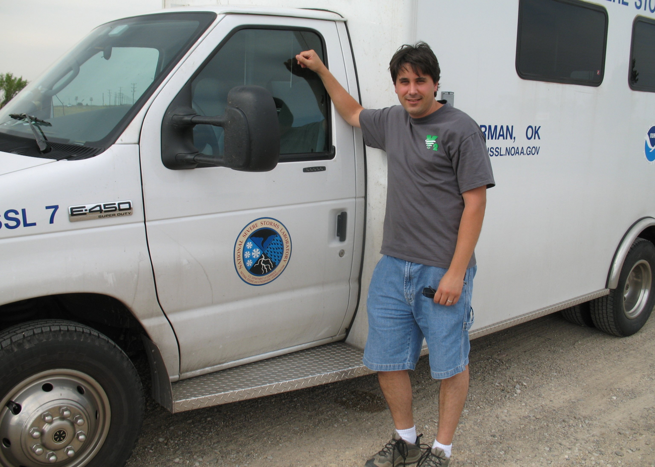 Mike Coniglio standing next to an NSSL chase truck