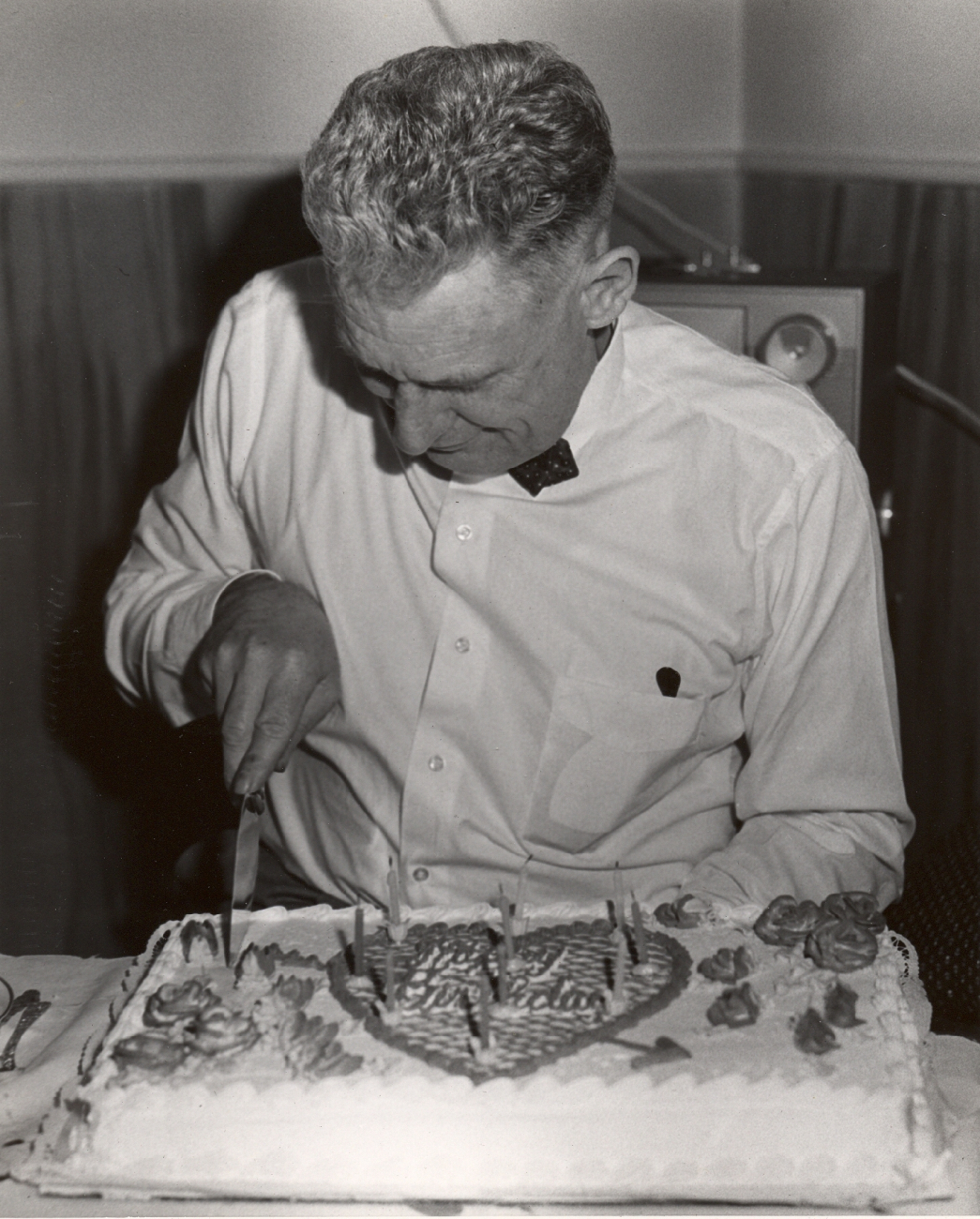 Commander David Whipp cutting birthday cake
