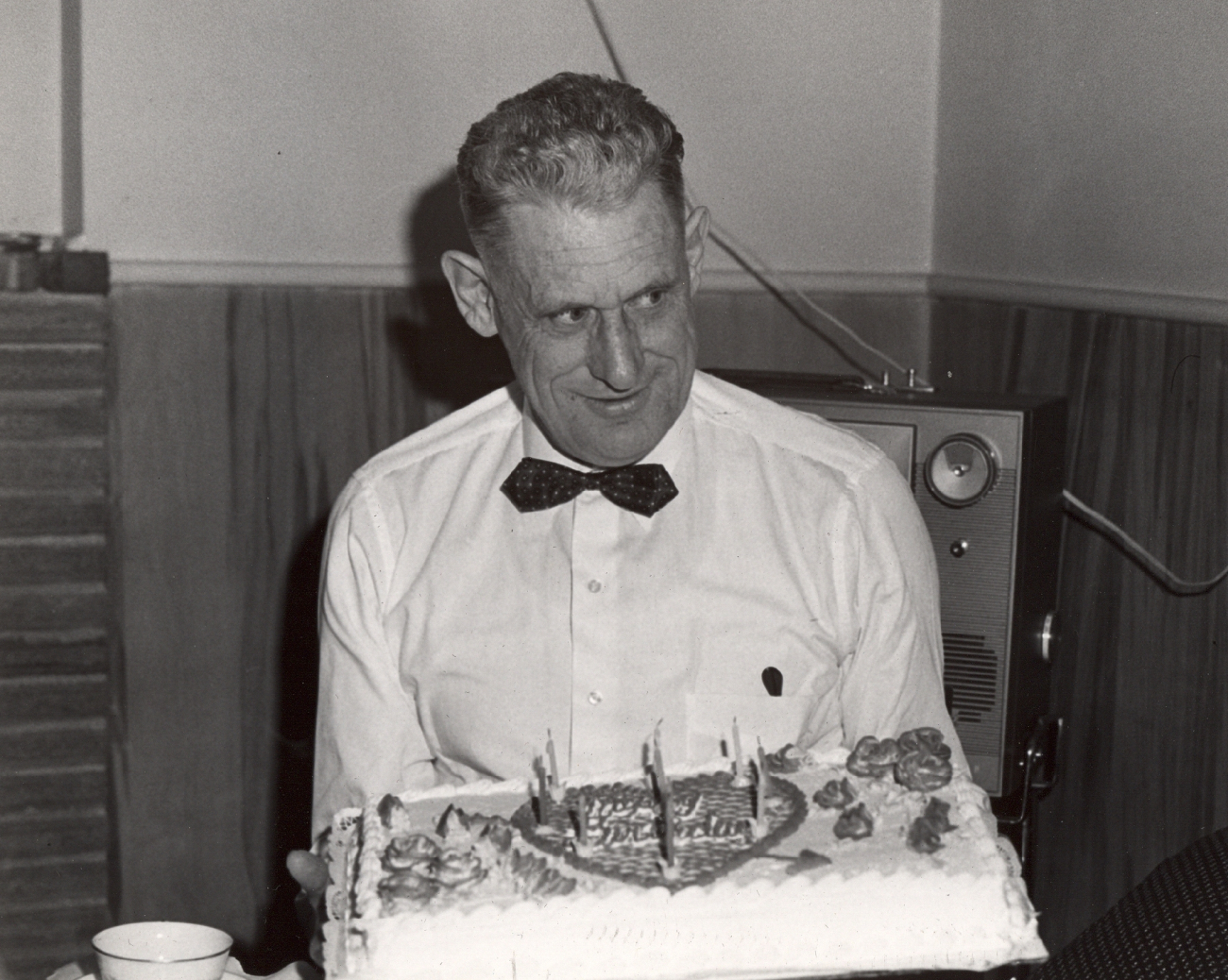 Commander David Whipp holding birthday cake