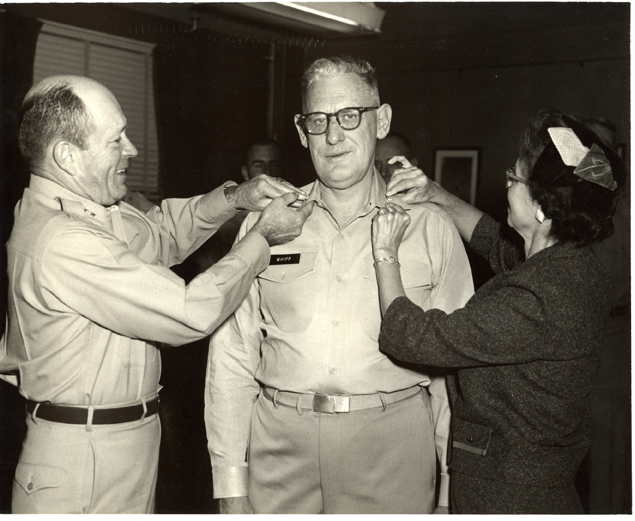 Captain David Whipp having his captain's eagles pinned on by Major General Harry H